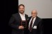 Dr. Nagib Callaos, General Chair, giving Dr. Christopher Amos a plaque "In Appreciation for Delivering a Great Keynote Address at a Plenary Session."